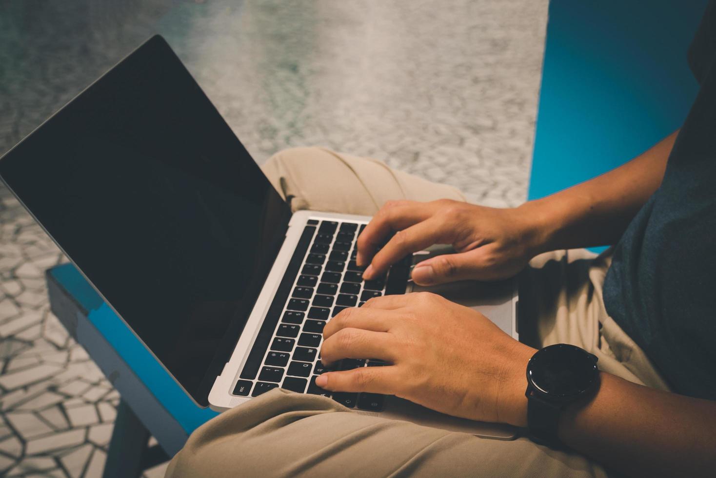 Man using laptop for business technology communication working, typing, and connecting to the internet while using a wireless network. photo