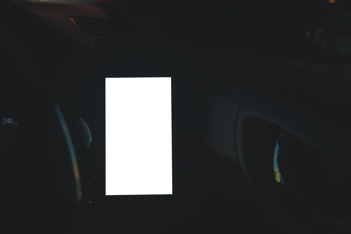 Mobile phone on the car air vent.Blank with white screen.Mock up smart phone in car.texting, copy space for your advertisement. photo