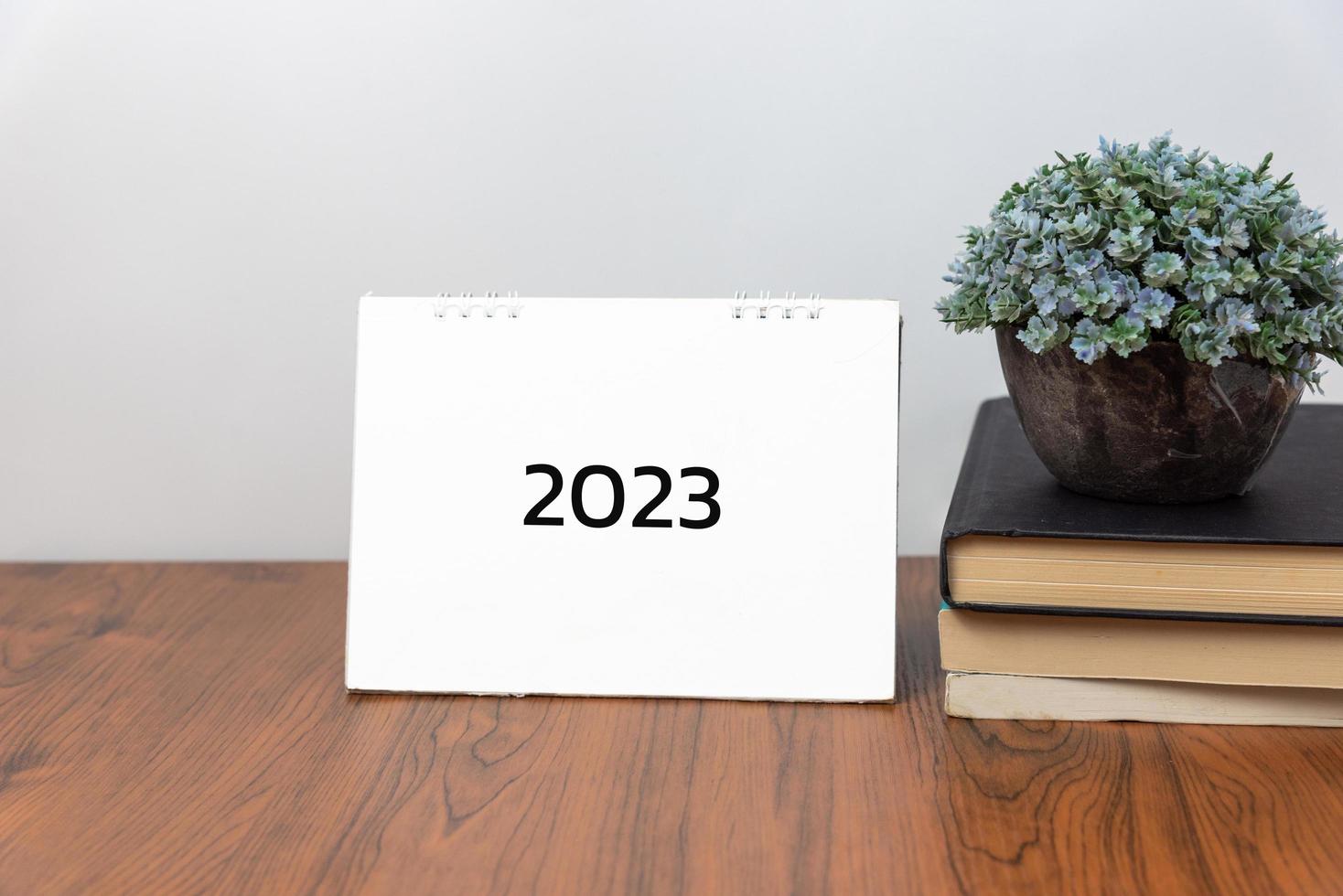 business idea, action concept. 2023 calendar book on desk background. photo