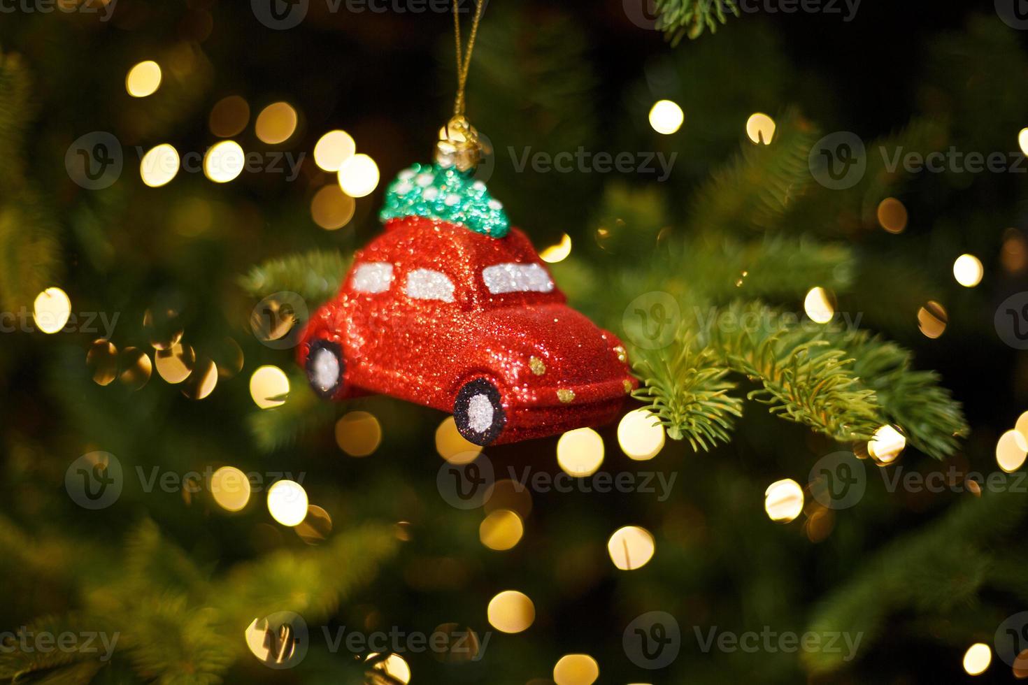 Toy red car on the Christmas tree photo