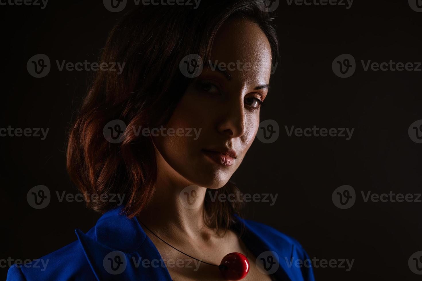 Close-up portrait of a beautiful woman, dark photo on a black background