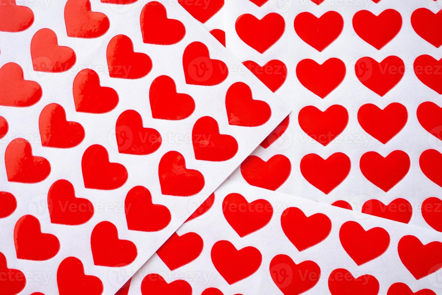 Close up red heart sticker on white paper photo