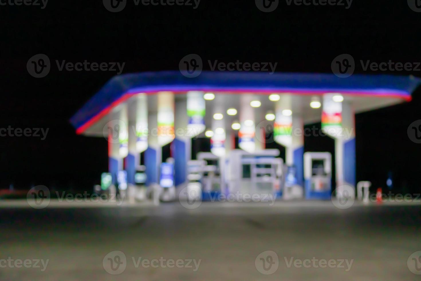 Petrol gas station at night time blurred background with bokeh light photo
