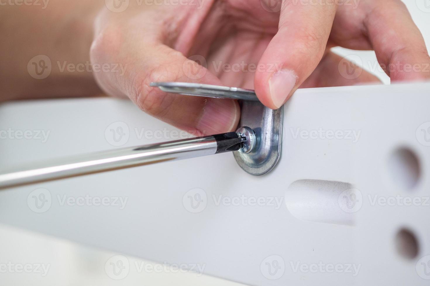 Assembly furniture using screwdriver at home photo