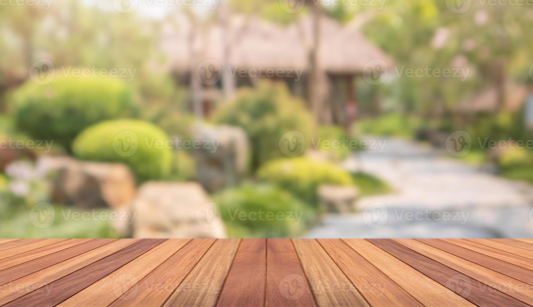 Empty wood table top with abstract blur park garden background photo