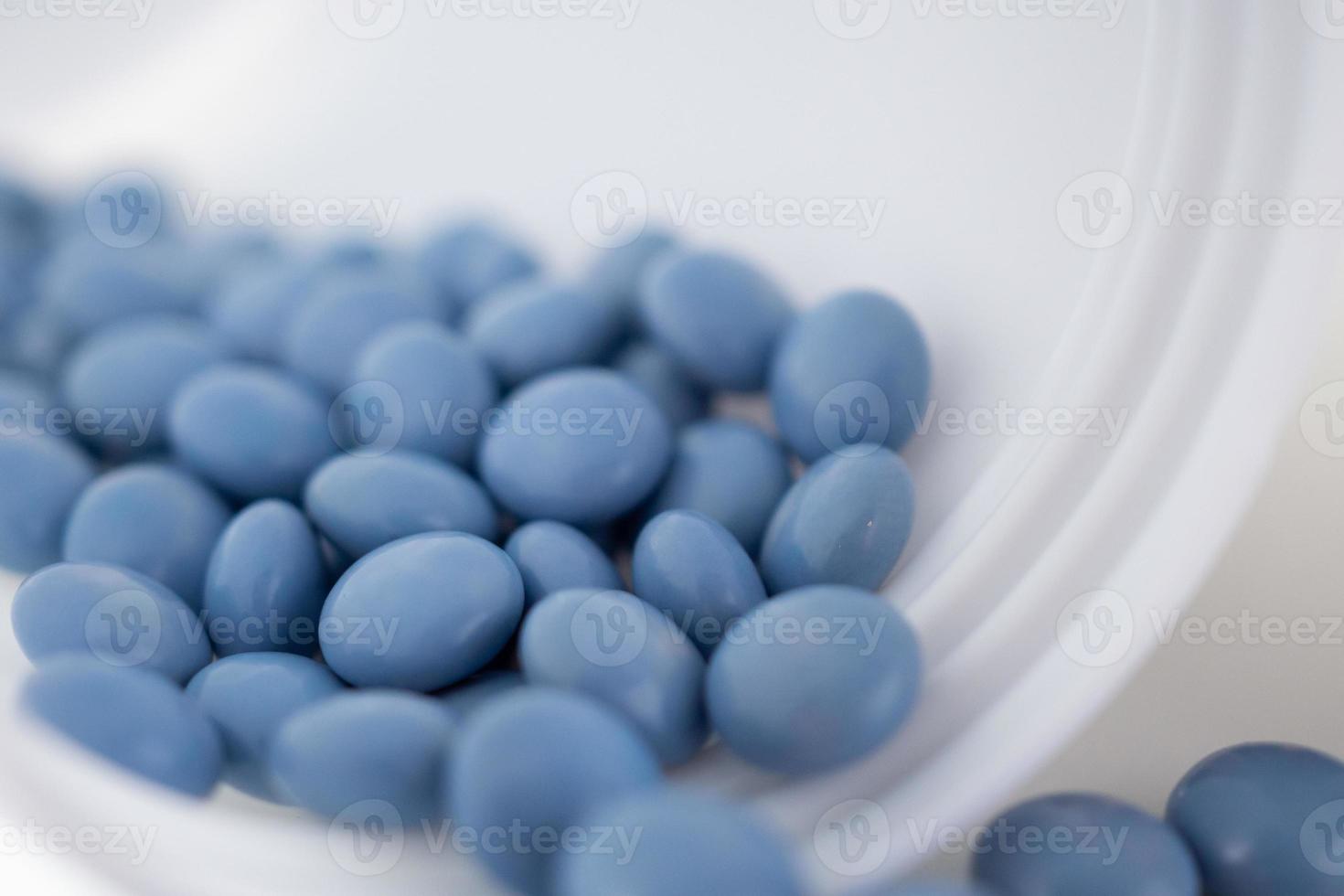 blue medicine pills with bottle on white background photo