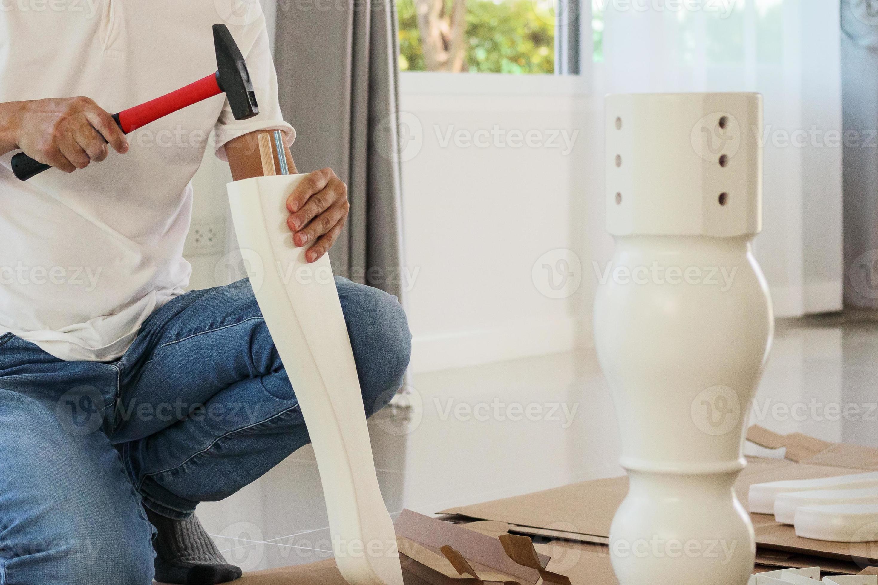 Man assembling furniture at home 13008861 Stock Photo at Vecteezy