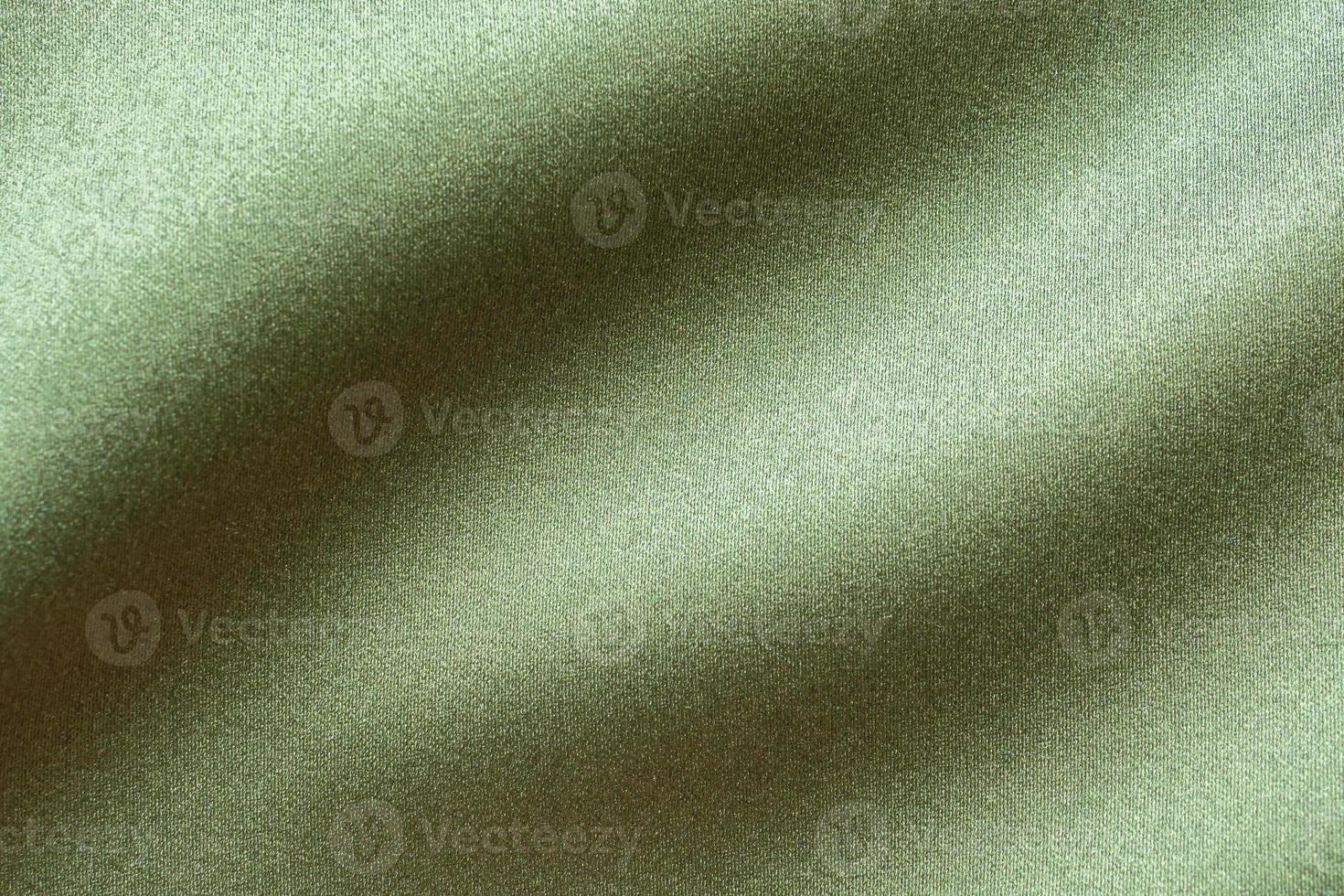 Green fabric texture background close up photo