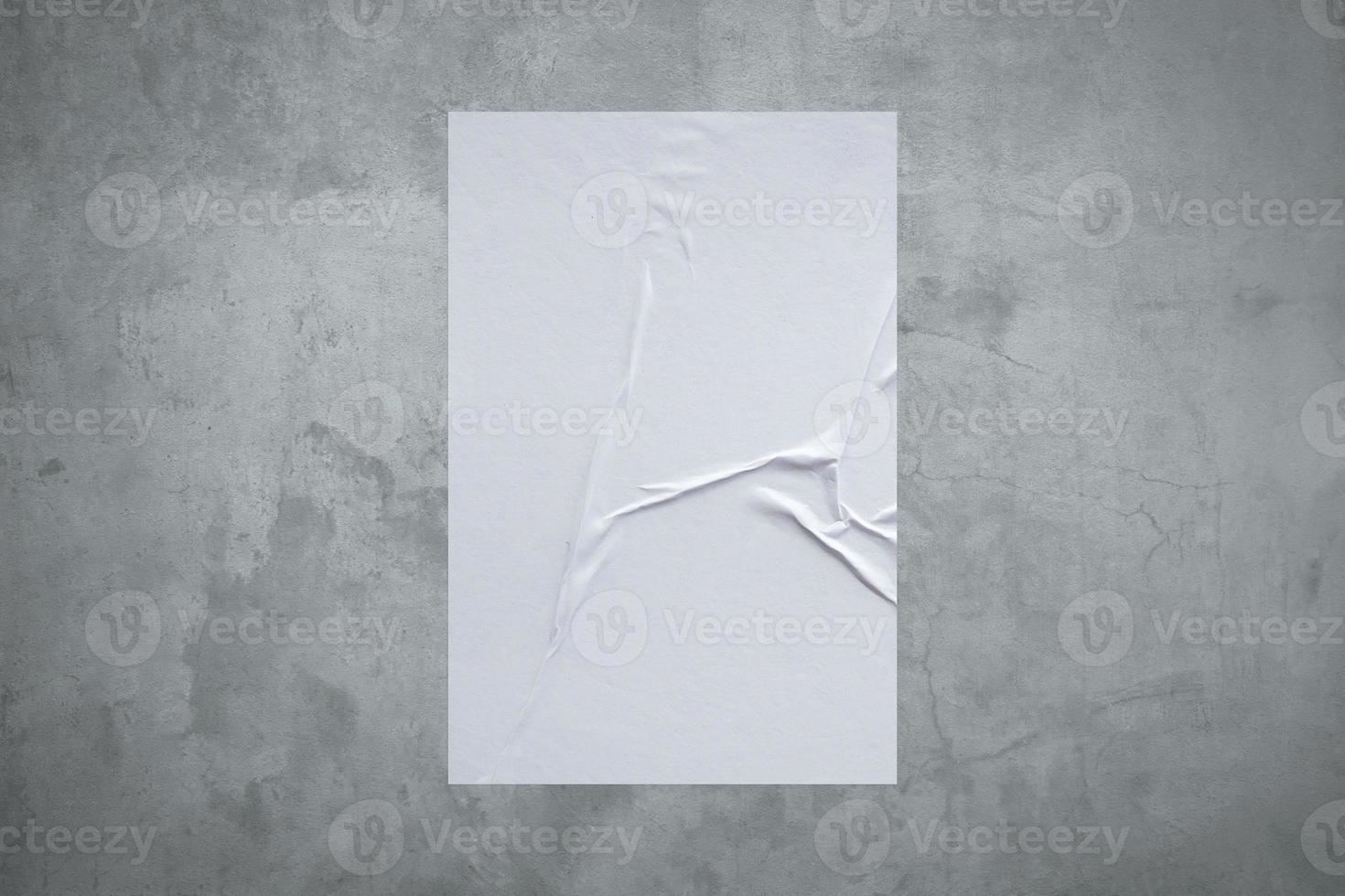 Blank white wheatpaste glued paper poster mockup on concrete wall background photo