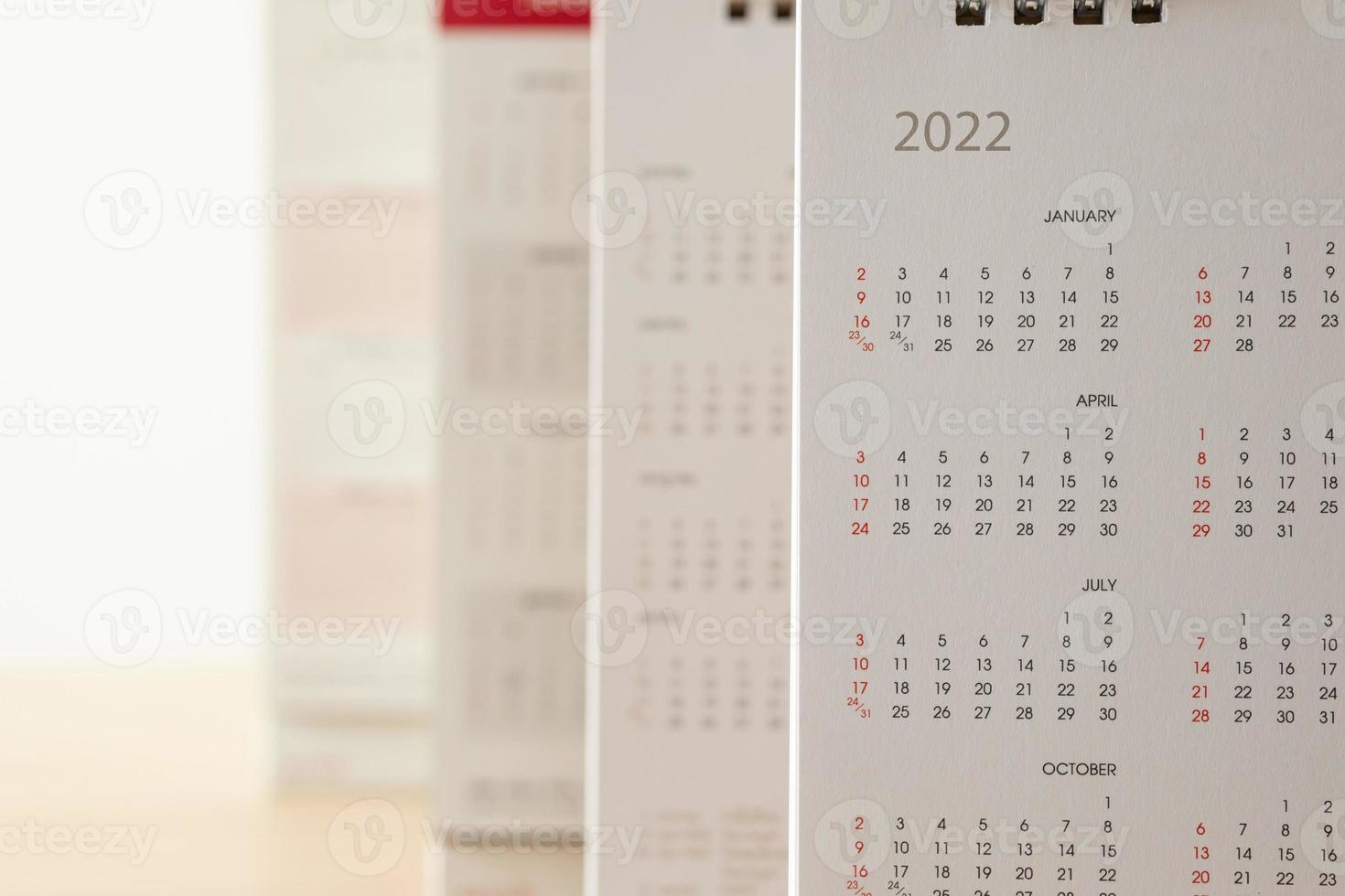 Close up 2022 calendar page dates and month background business planning appointment meeting concept photo