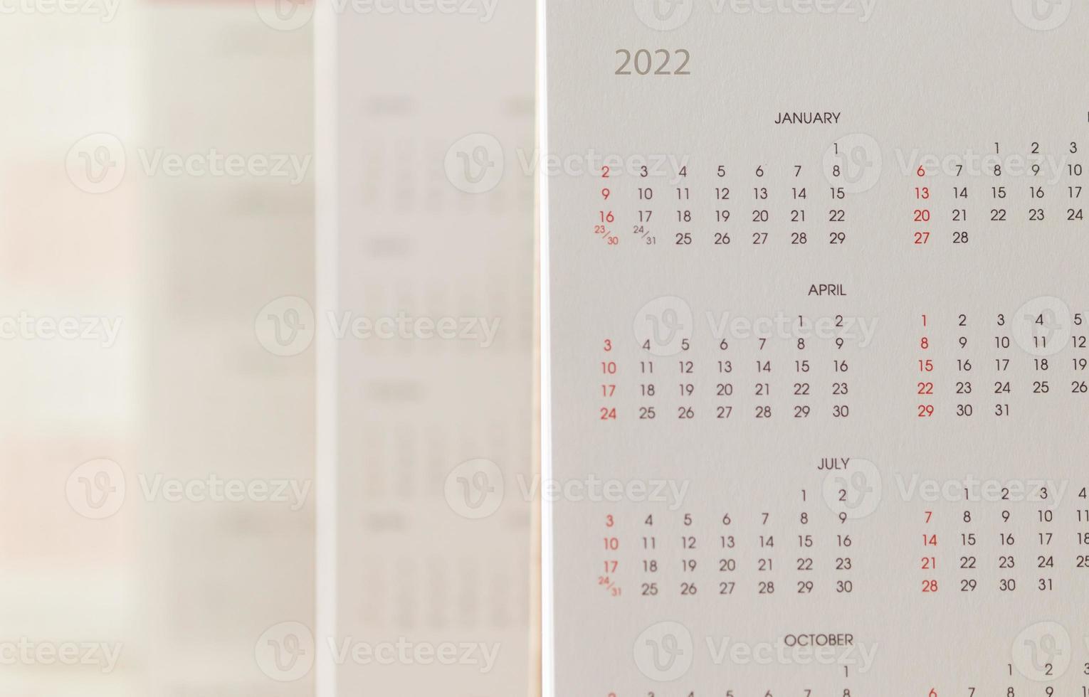 Close up 2022 calendar page dates and month background business planning appointment meeting concept photo