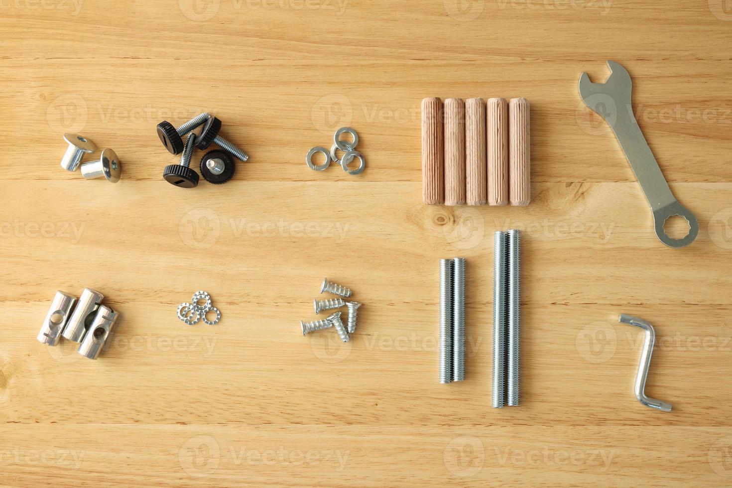 Assembly furniture tool kit with screw dowel wrench and bolt on wood table photo