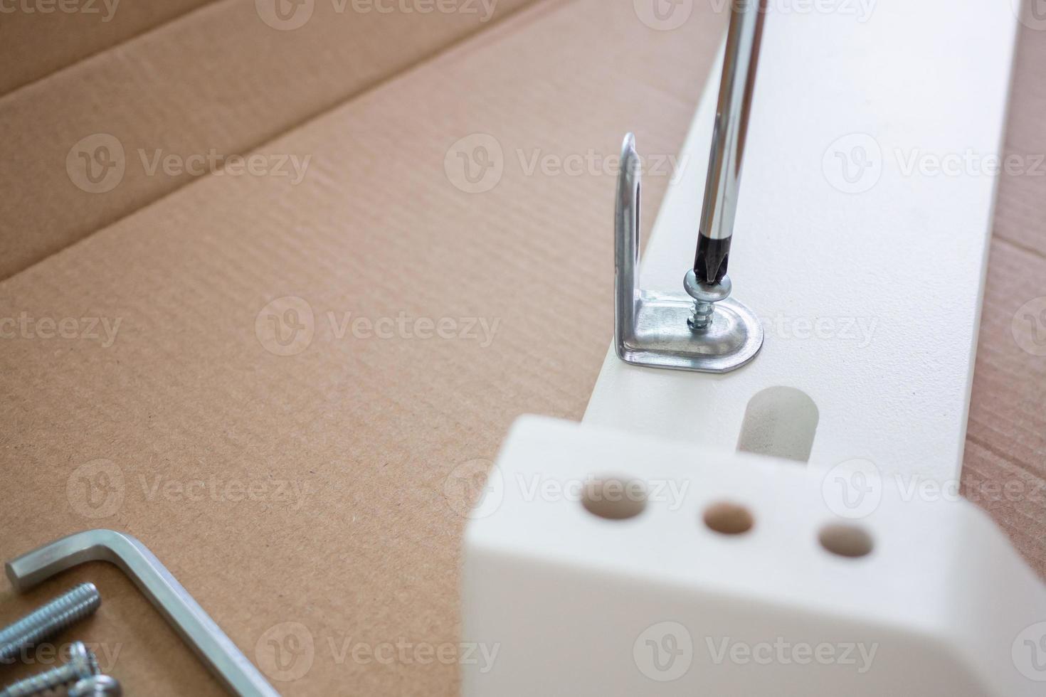 Assembly furniture using screwdriver at home photo