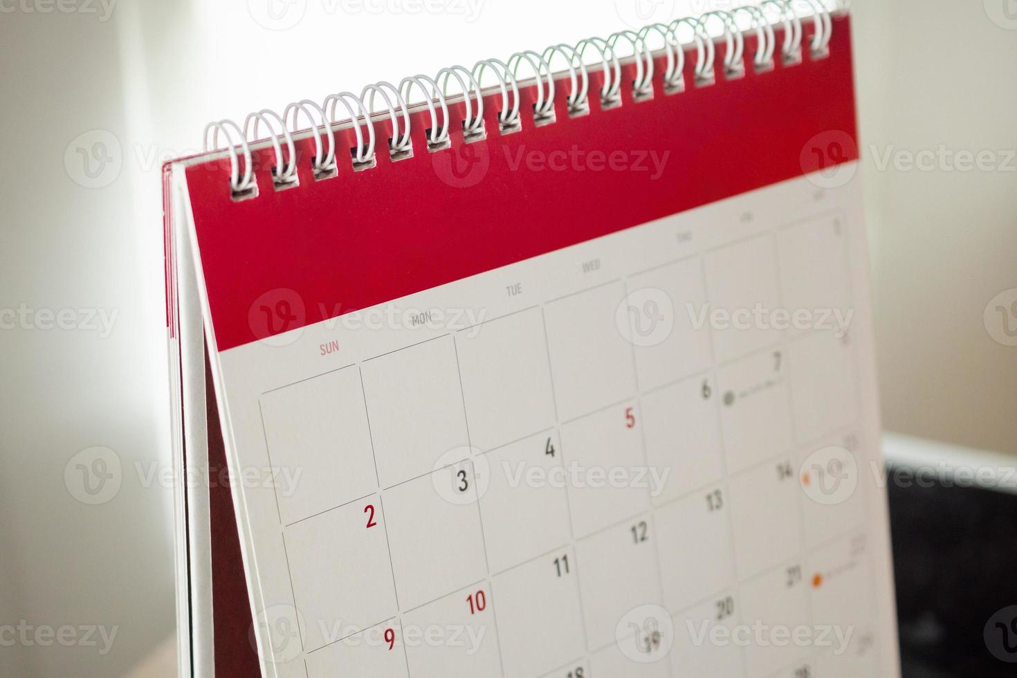 Calendar page close up with white wall background business planning appointment meeting concept photo