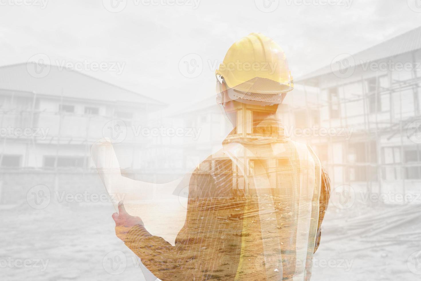 Double exposure image of professional engineer in protective helmet and blueprints paper at the house building construction site photo