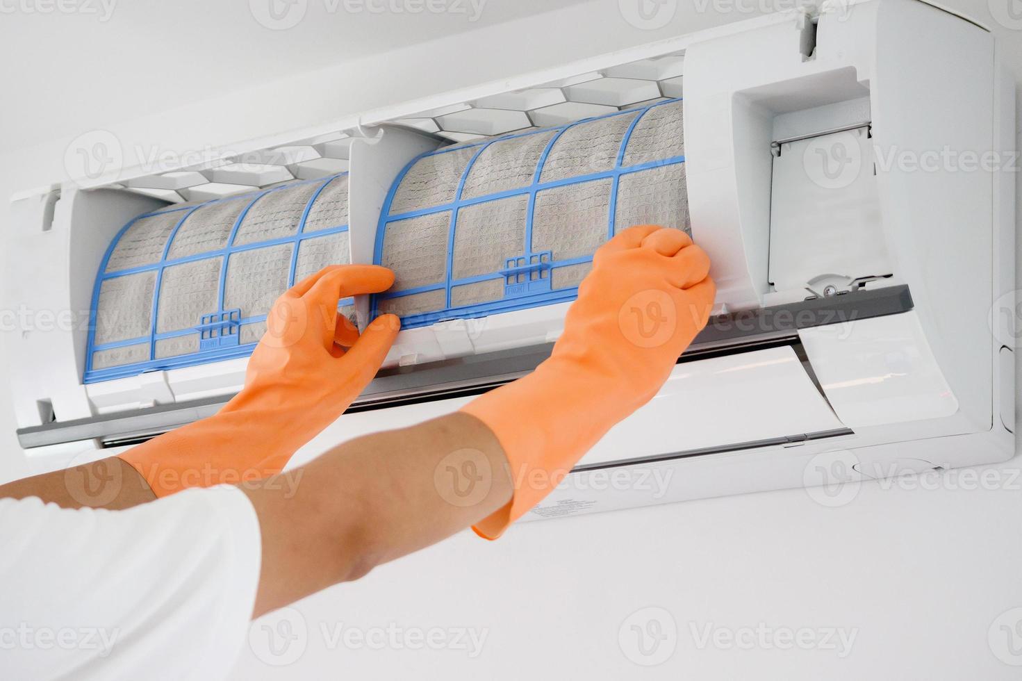 Asian man cleaning air conditioner dirty filter photo