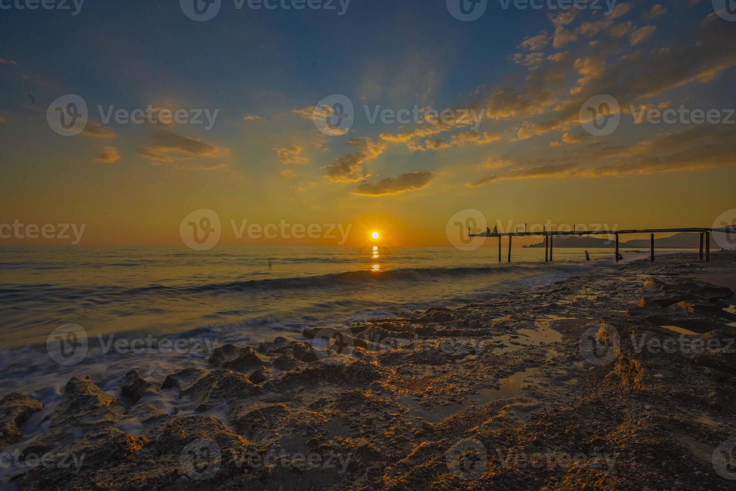 Beautiful shot of a long  at sunset Warm sunset tones of orange, yellow, pink, blue and purple. Smooth water and reflection photo