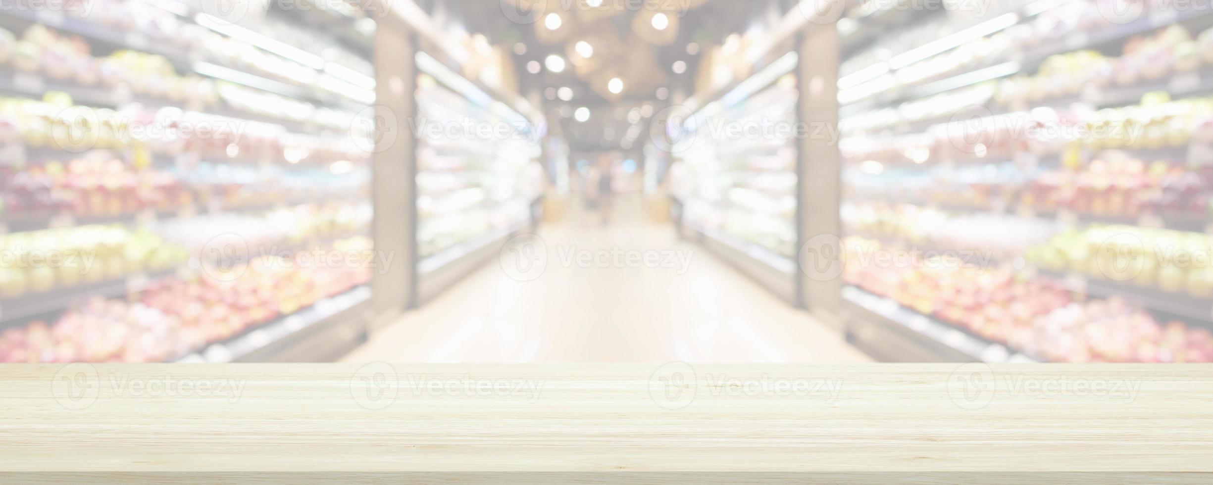 Wood table top with supermarket grocery store blurred background with bokeh light for product display photo