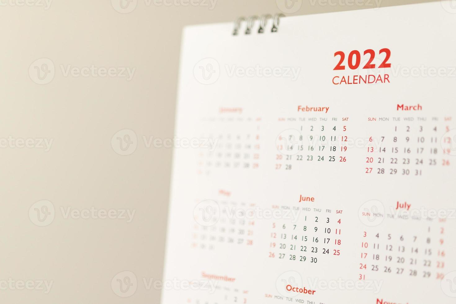 Close up 2022 calendar page dates and month background business planning appointment meeting concept photo