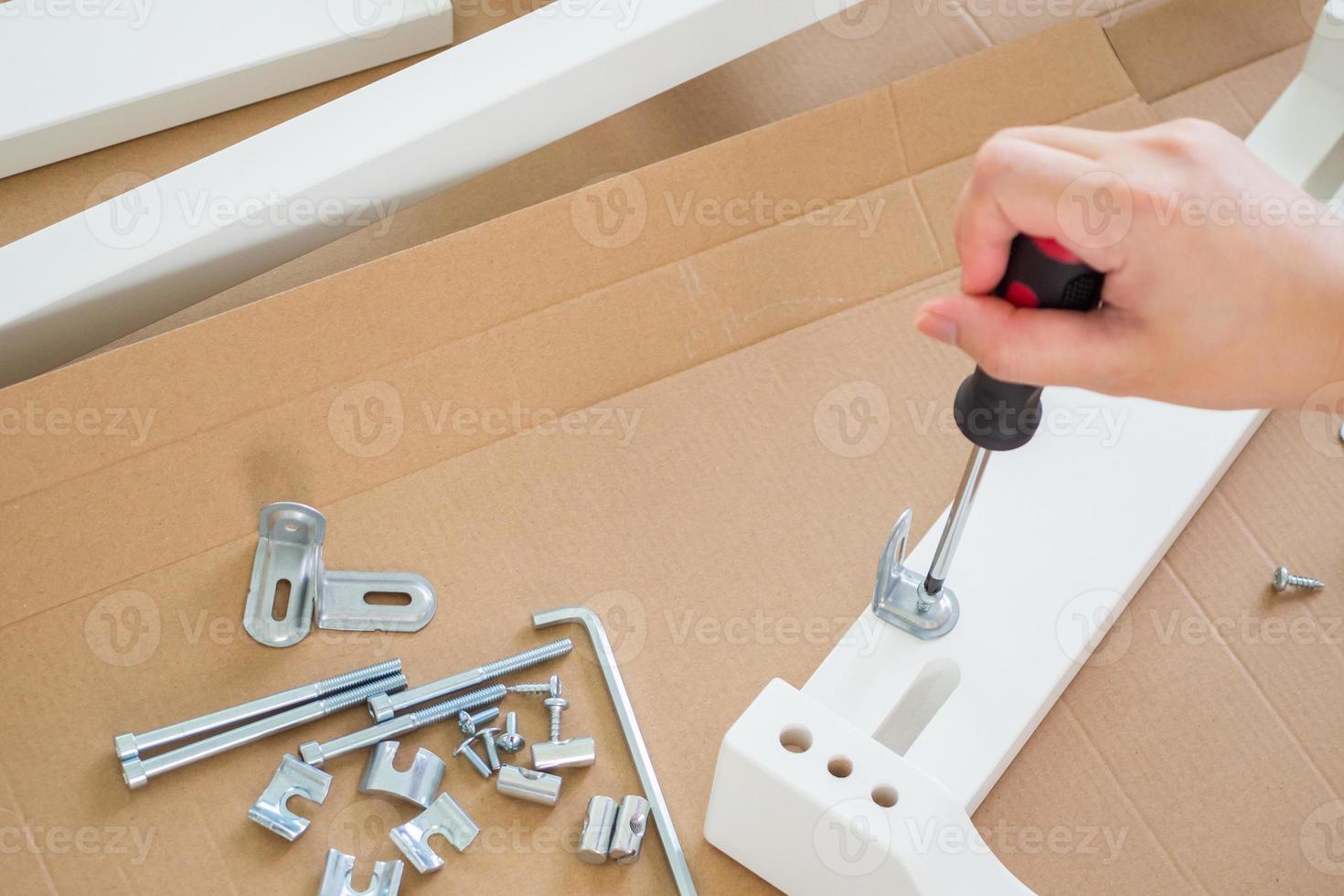 Assembly furniture using screwdriver at home photo