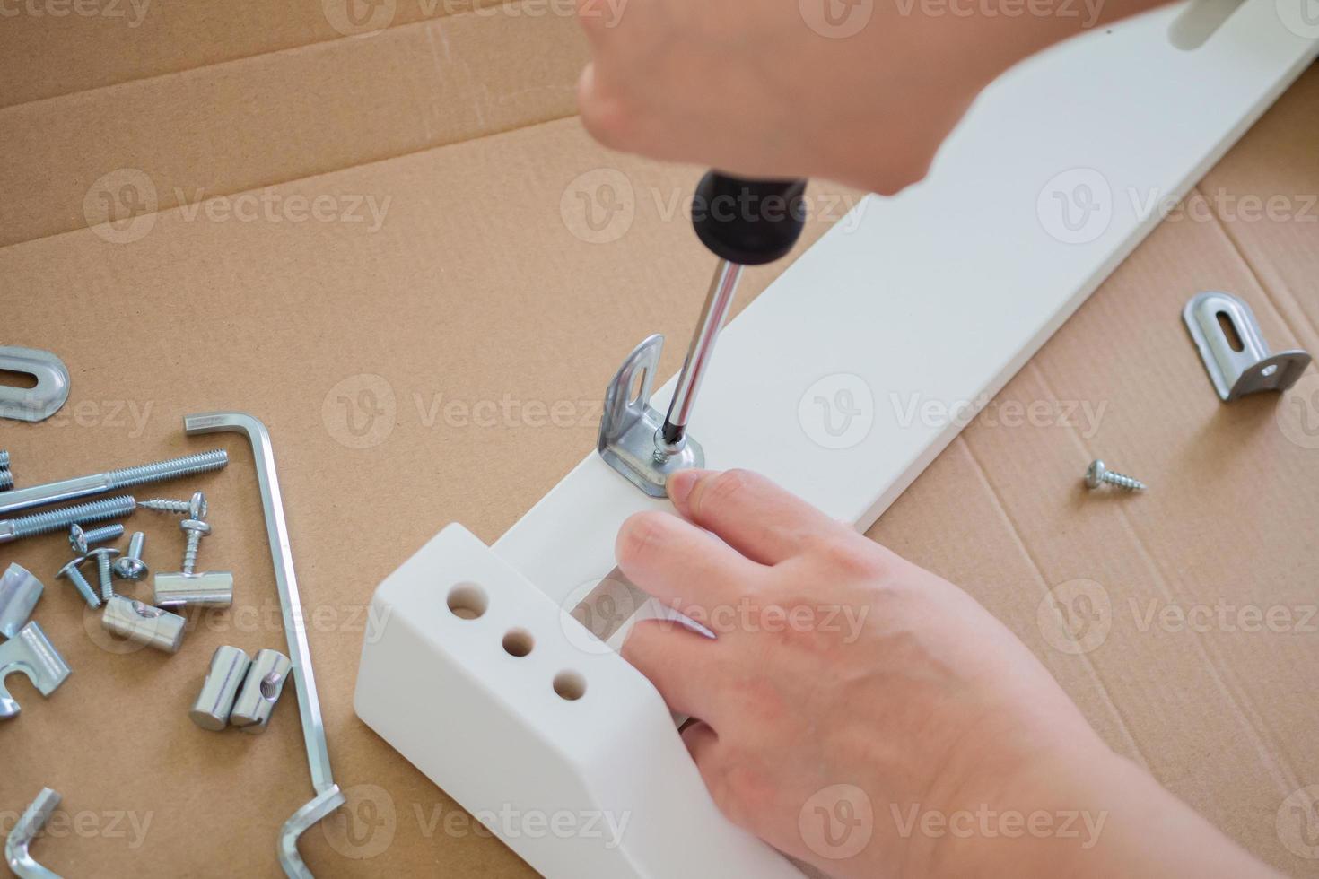 Assembly furniture using screwdriver at home photo