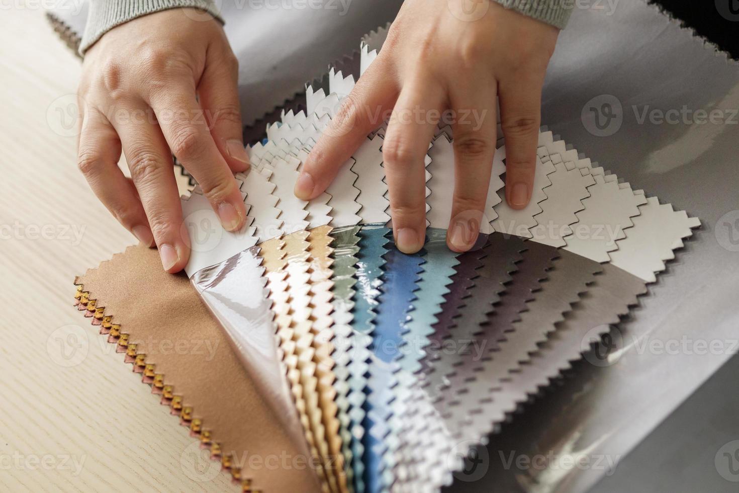 female designer with fabric color samples choosing textile for curtains photo