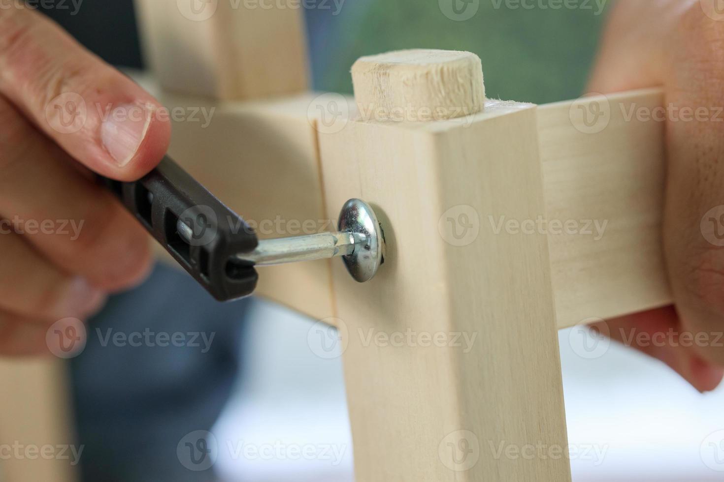 Assembly wooden furniture at home using screw allen photo