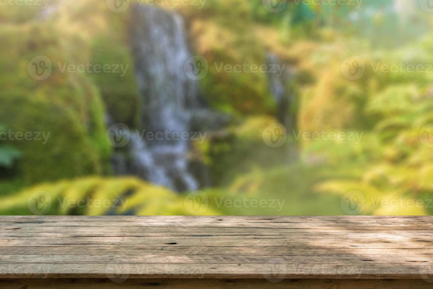Empty wood table top with abstract blur park garden pond background photo