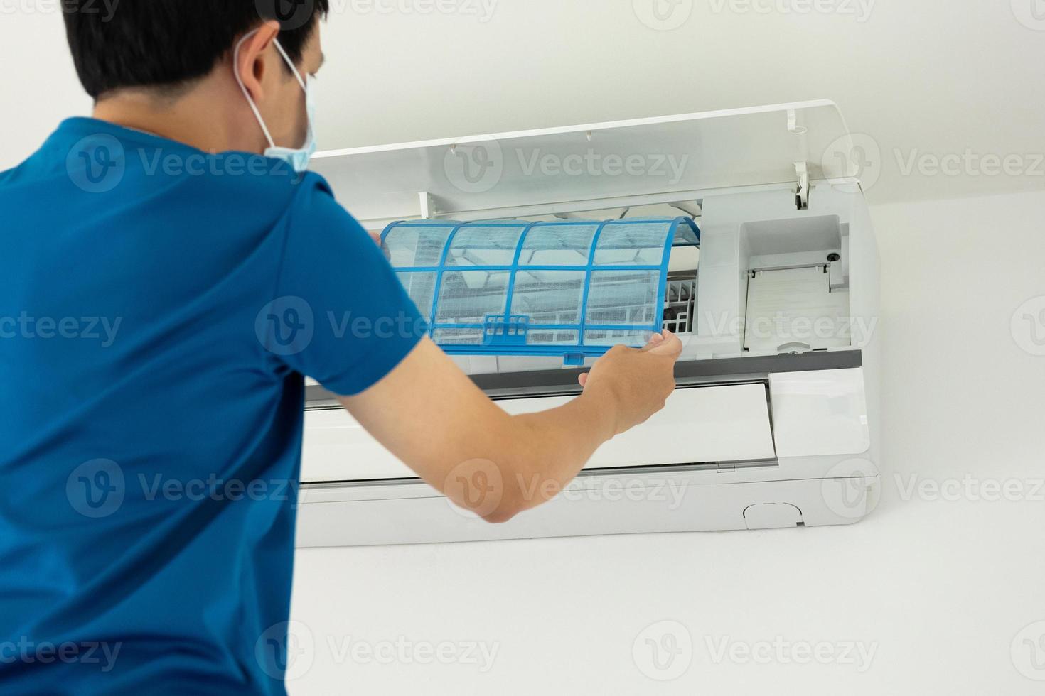 Asian man cleaning air conditioner filter photo