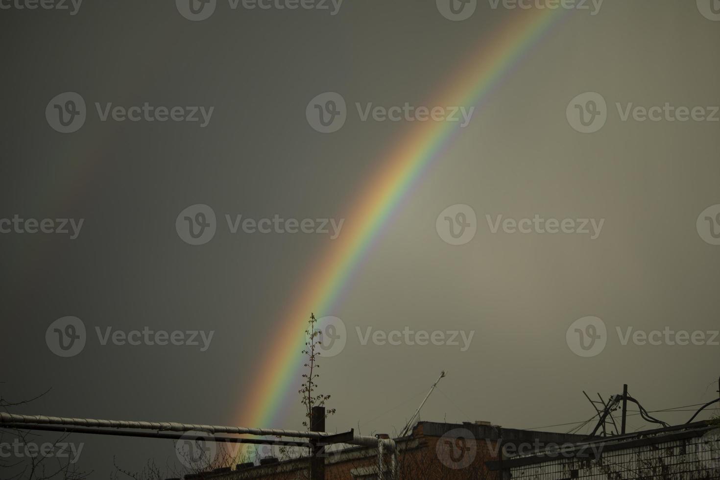 Rainbow in sky. Beautiful weather. Decomposition of light into colors. photo