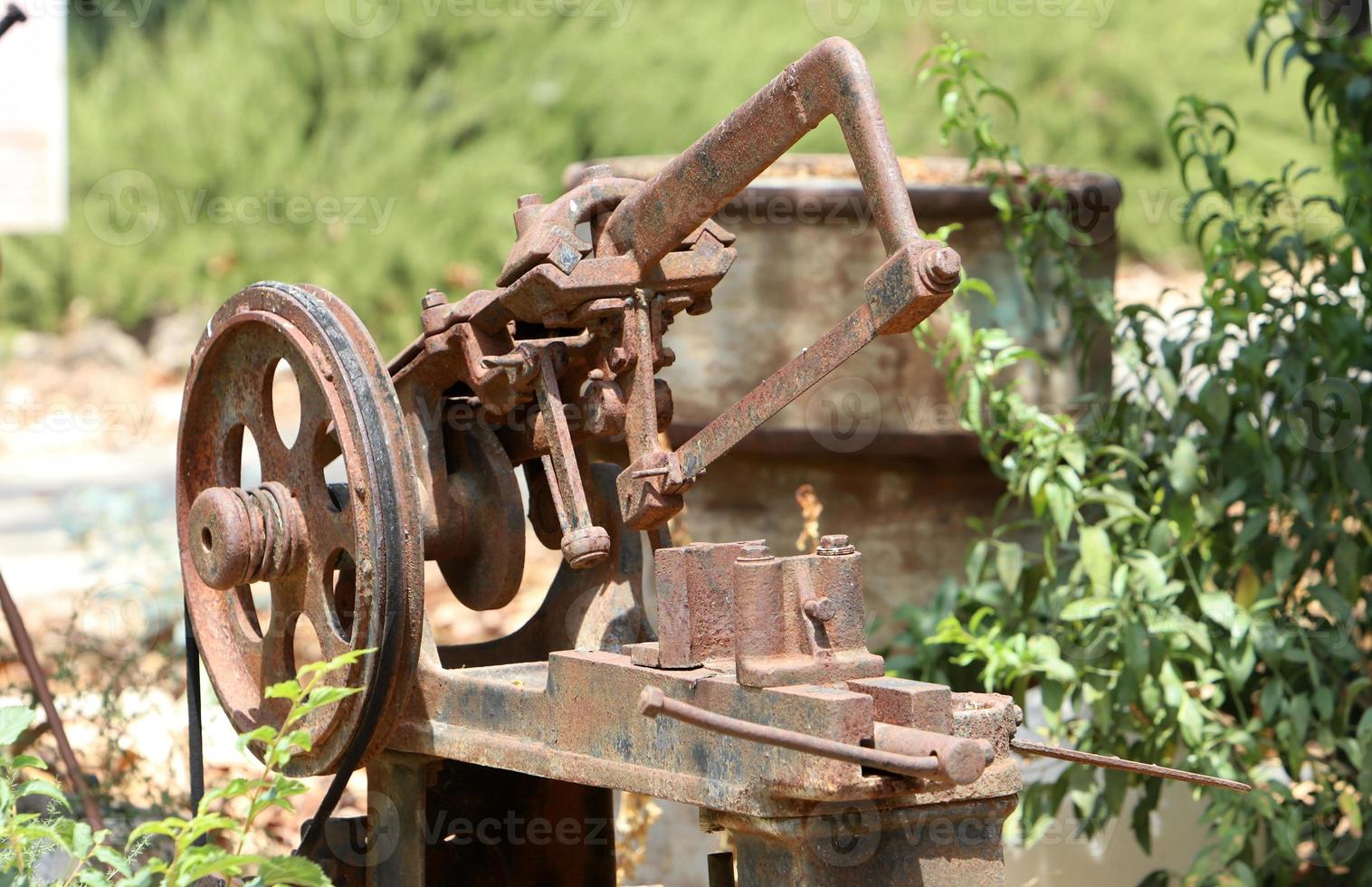 Old agricultural machinery stands on the street in Israel and rusts photo