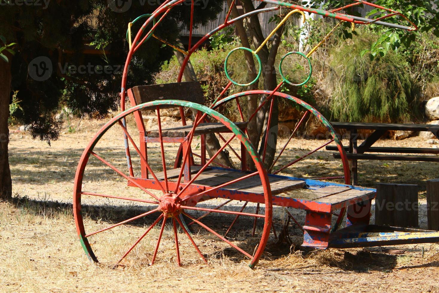 Old agricultural machinery stands on the street in Israel and rusts photo