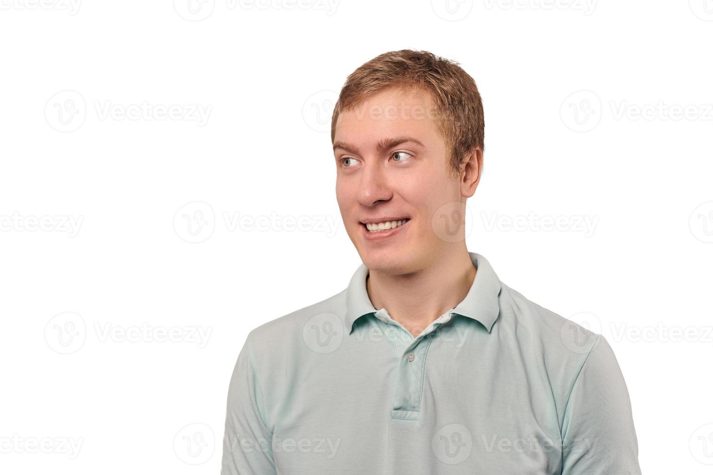 Portrait of funny young guy looking left in mint T-shirt isolated on white background photo
