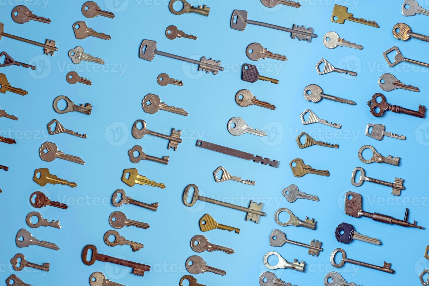 Keys set on blue background. Door lock keys and safes for property security and house protection. Different antique and new types of keys. photo