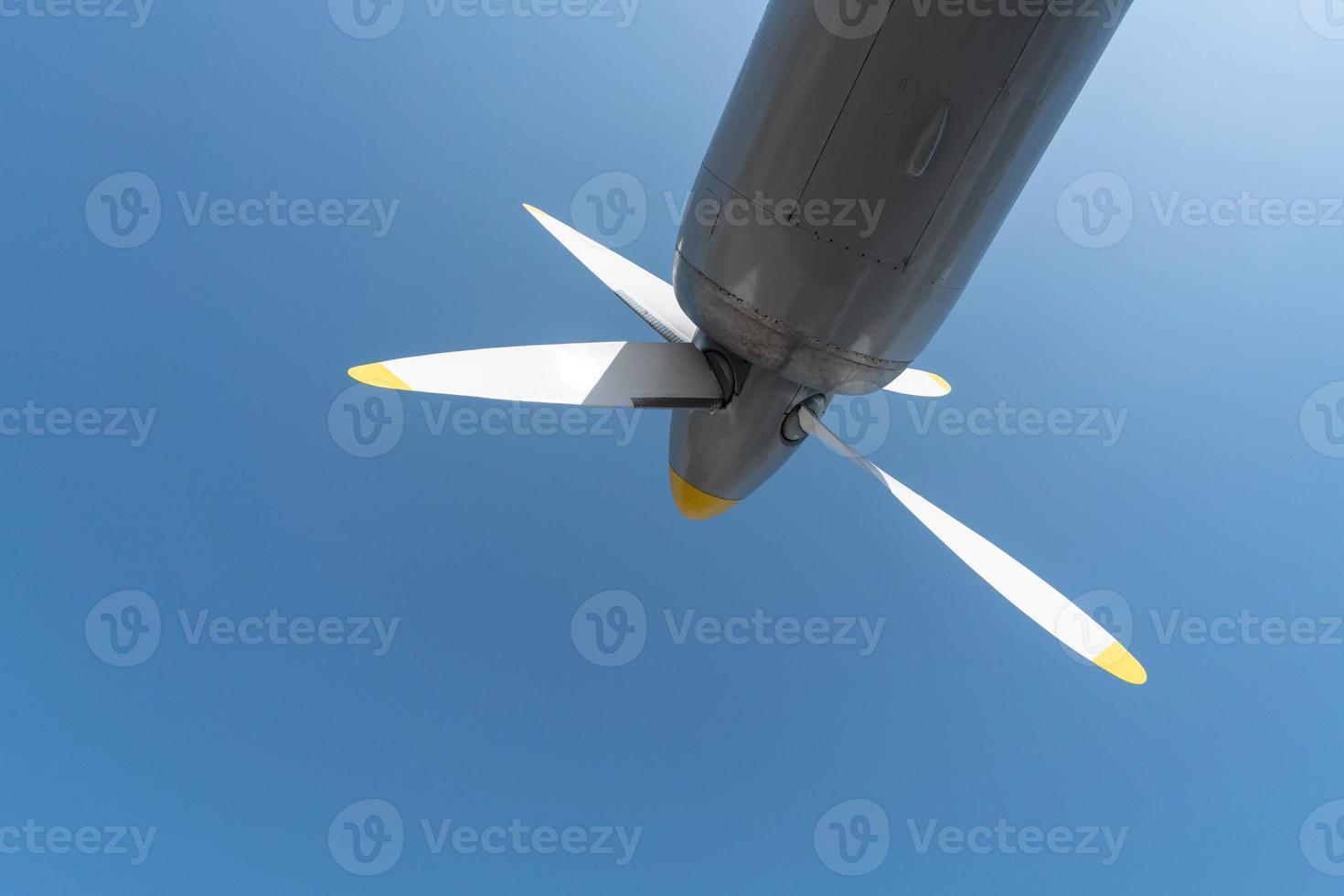Airplane propeller of military aircraft, copy space. Blue sky background. photo