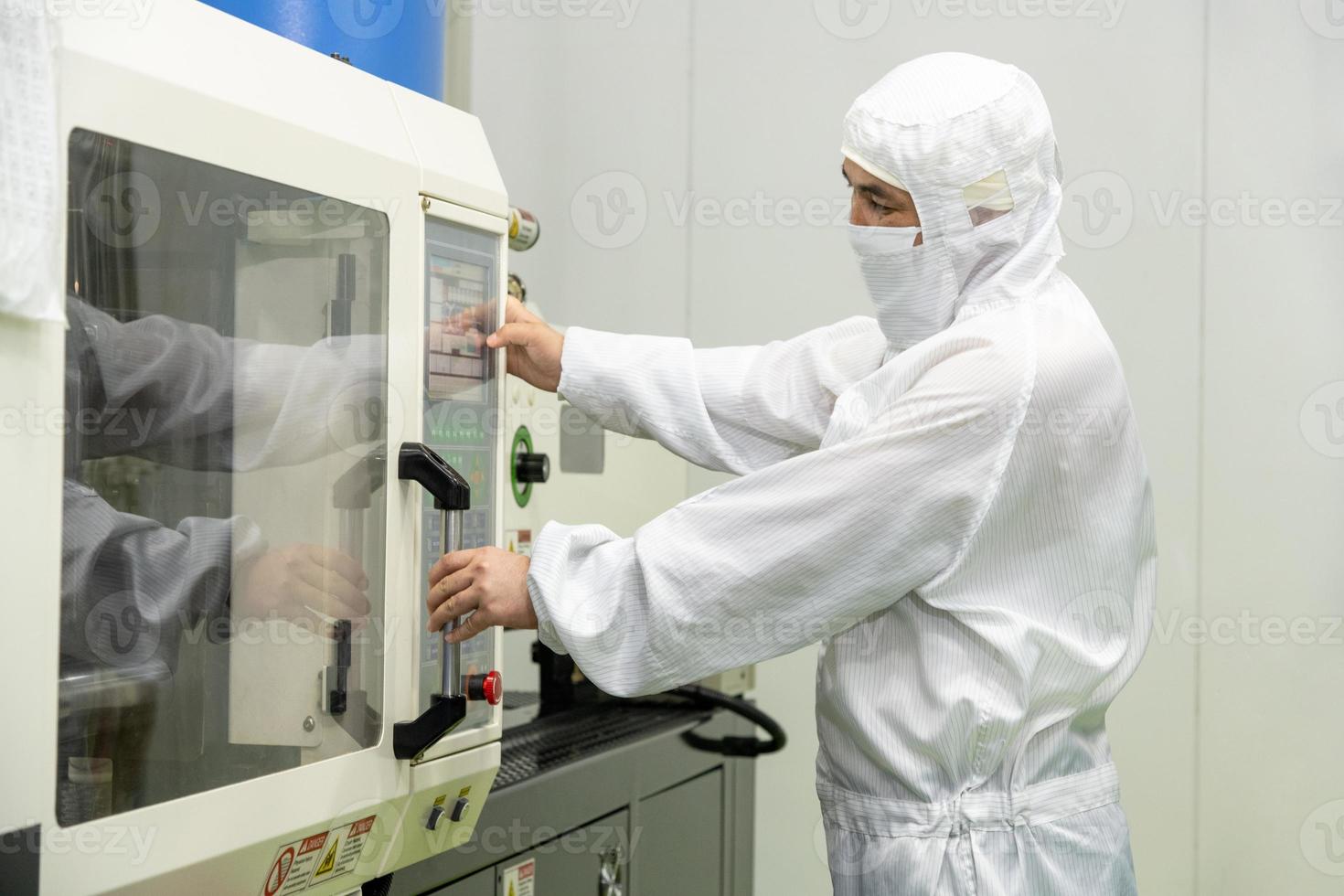 The workers in the workshop with molding machine for the production of medical production photo