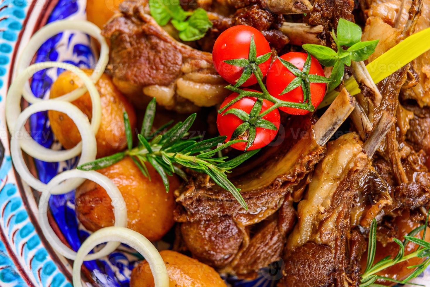A top view of a national Uzbek dish with meat and potatoes photo