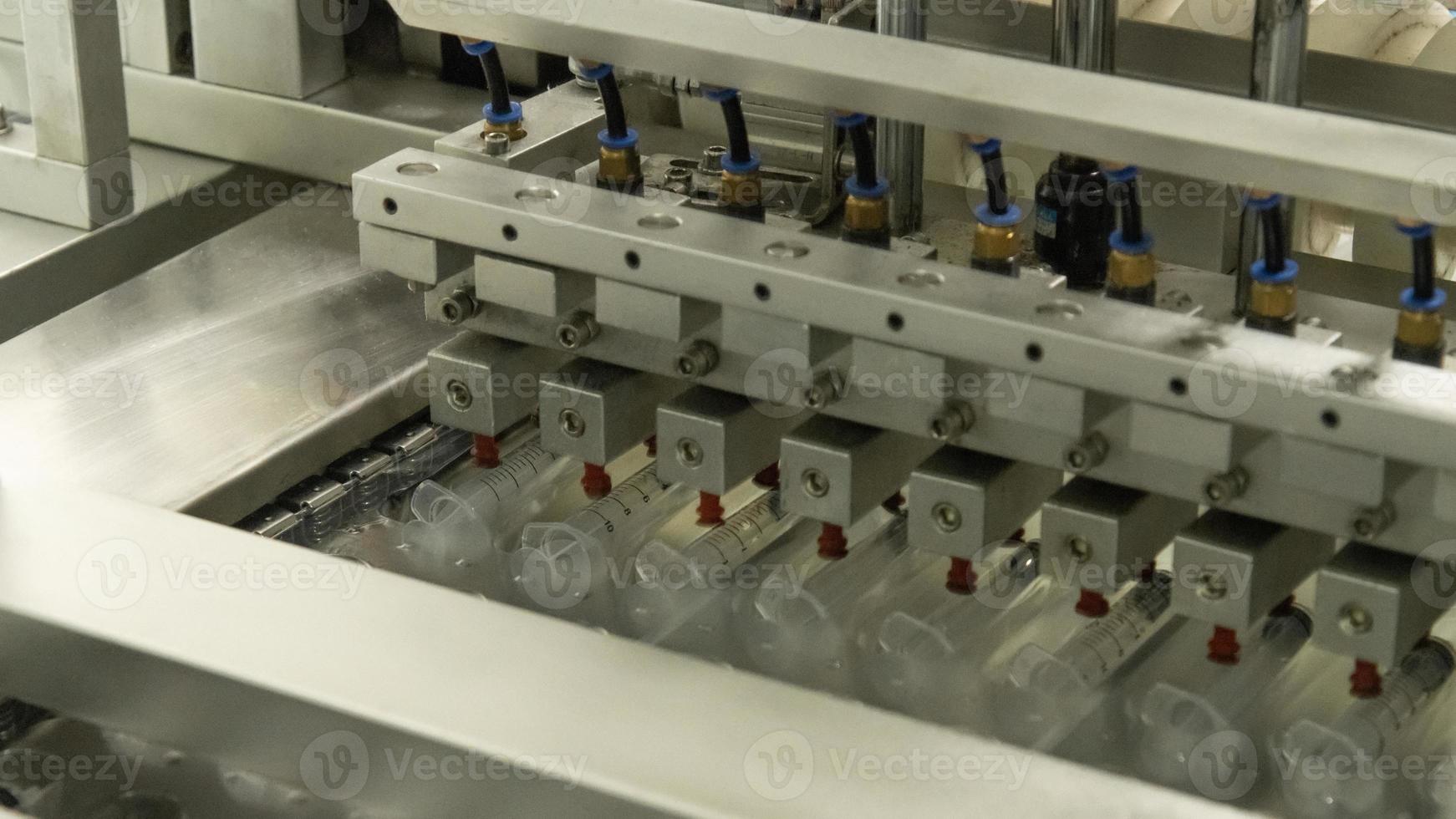 A closeup of the production of medical syringes photo