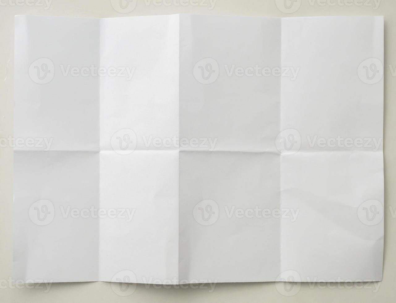 White folded and wrinkled paper on white background photo