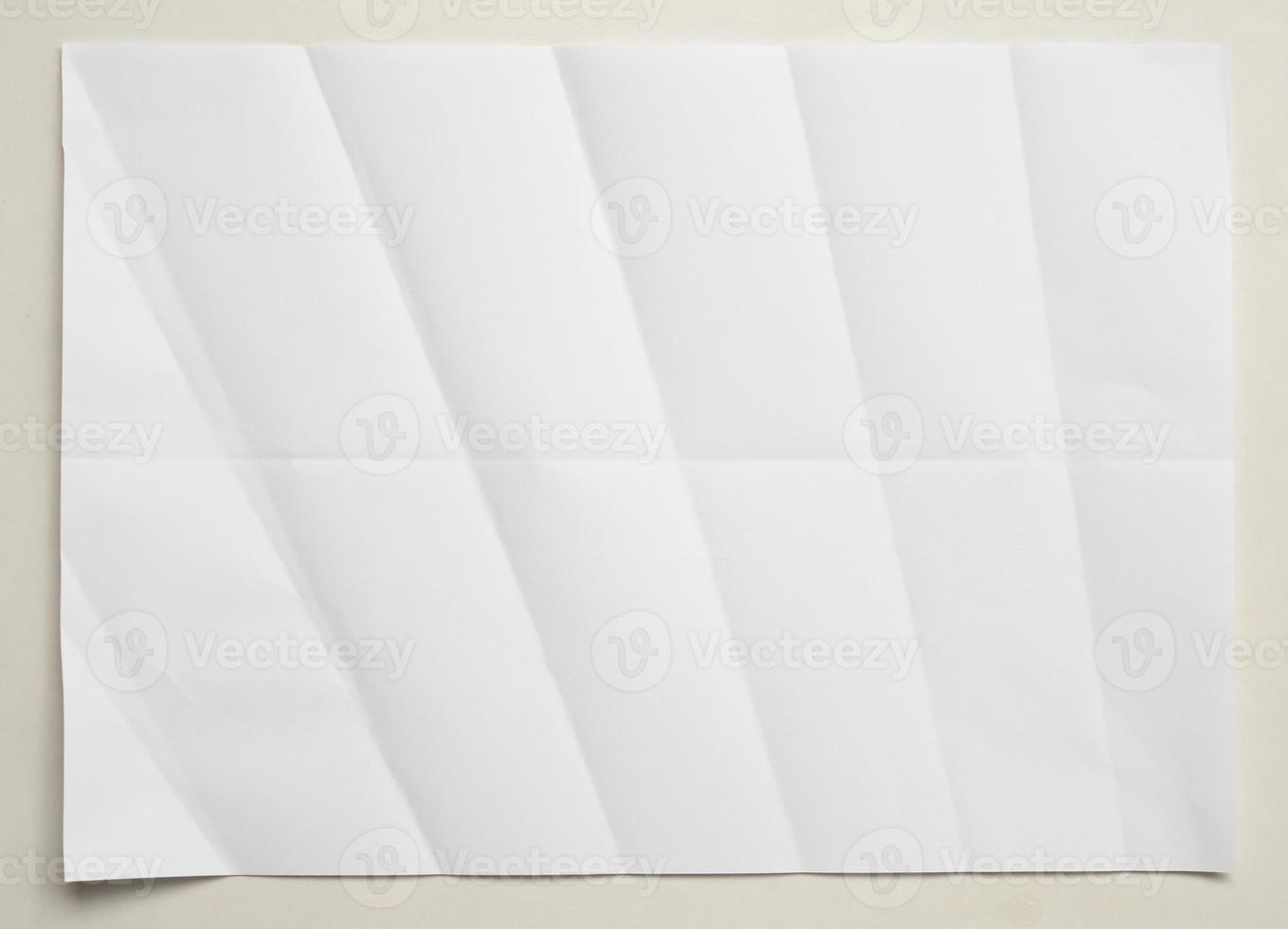 White folded and wrinkled paper on white background photo