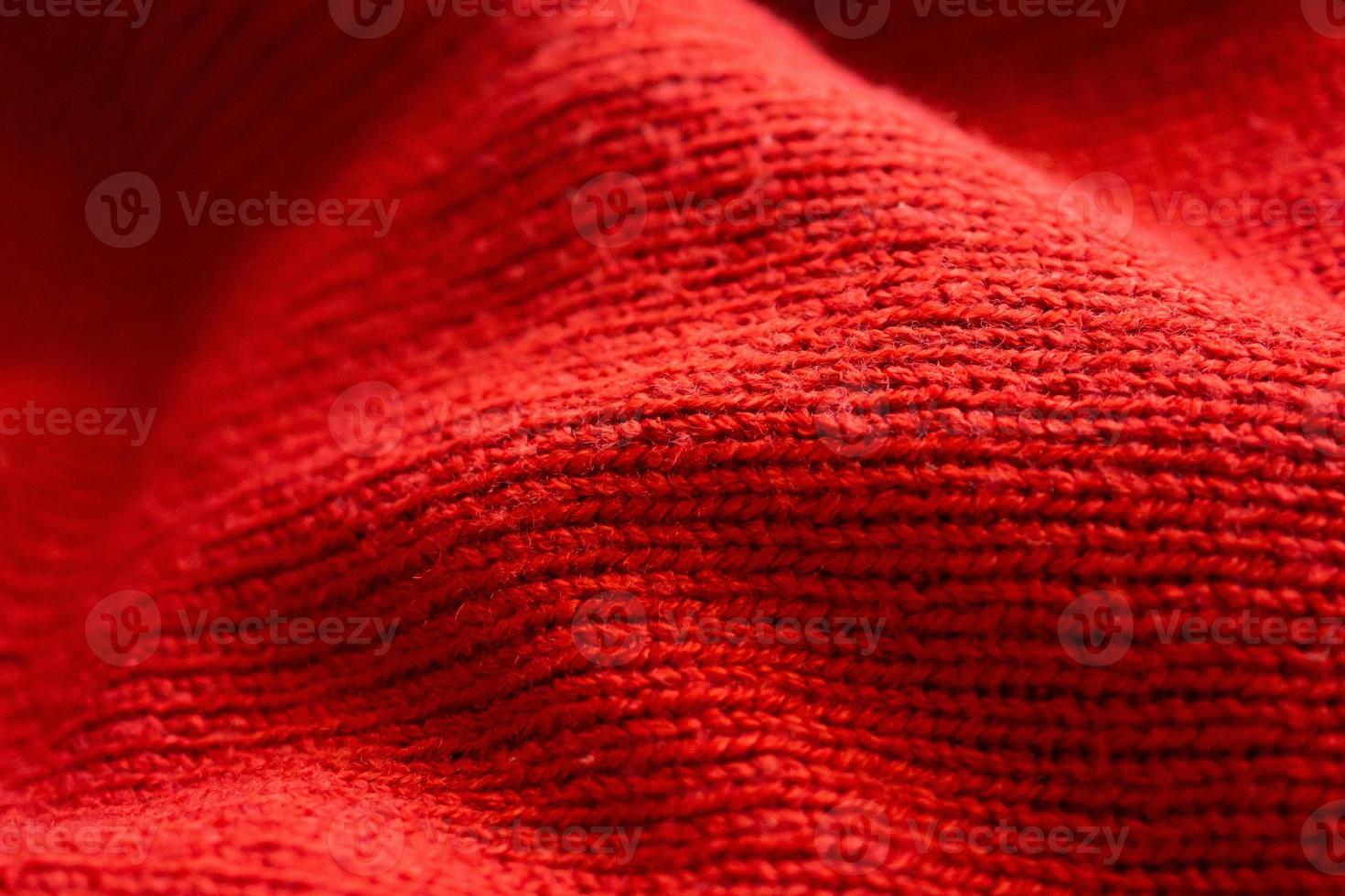 closeup red knitted woolen fabric texture background photo