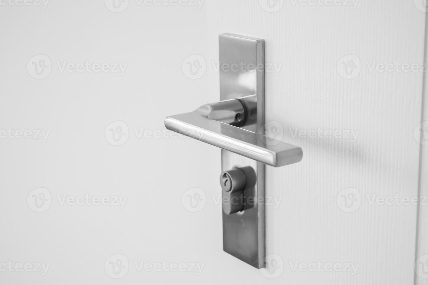 Modern door handle with on white door photo