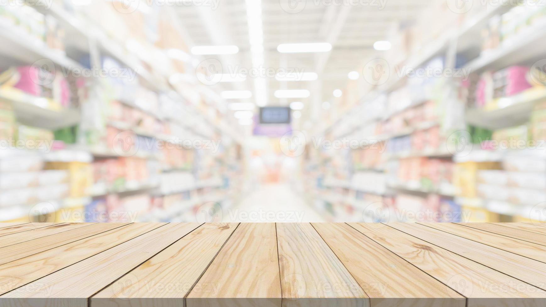 Wood table top with supermarket grocery store aisle interior blurred background with bokeh light for product display photo