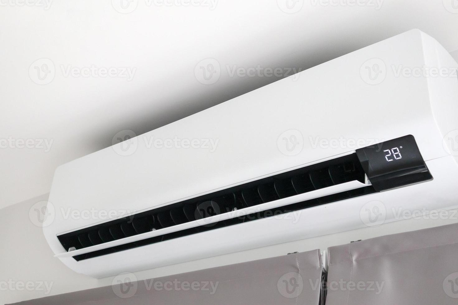Air conditioner on white wall room interior background photo