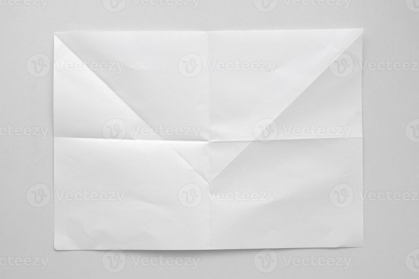 White folded and wrinkled paper on white background photo