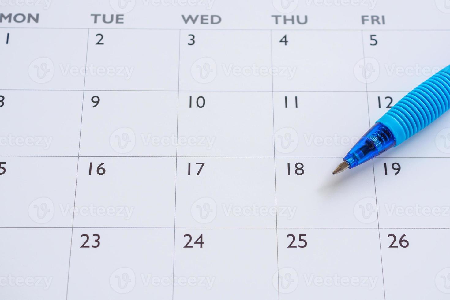 Blue pen on calendar page background business planning appointment meeting concept photo