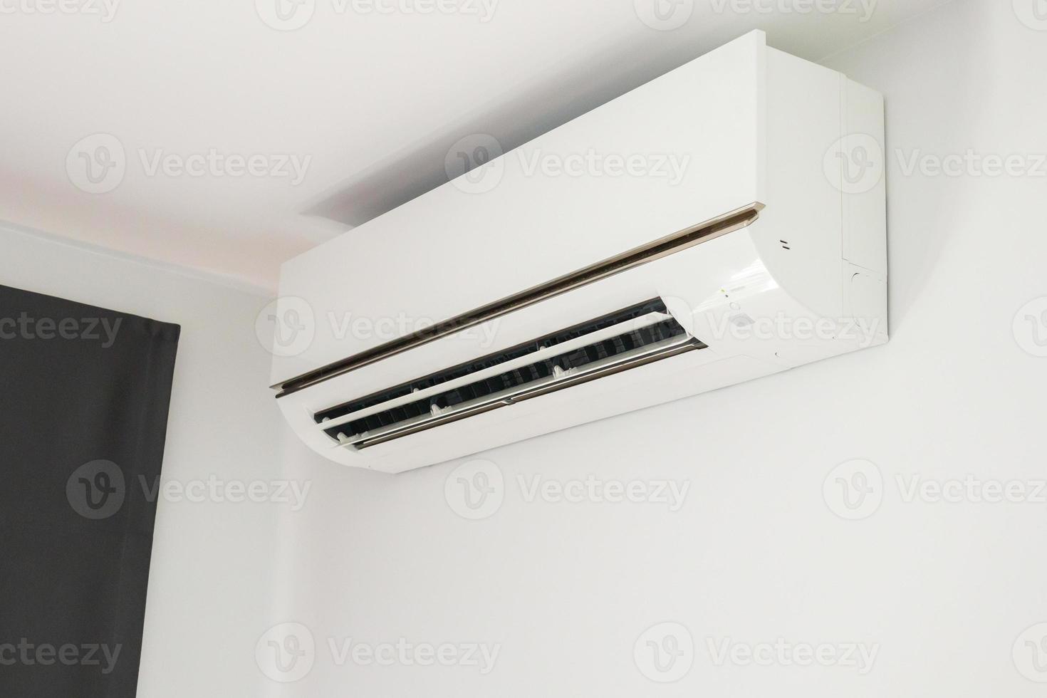 Air conditioner on white wall room interior background photo