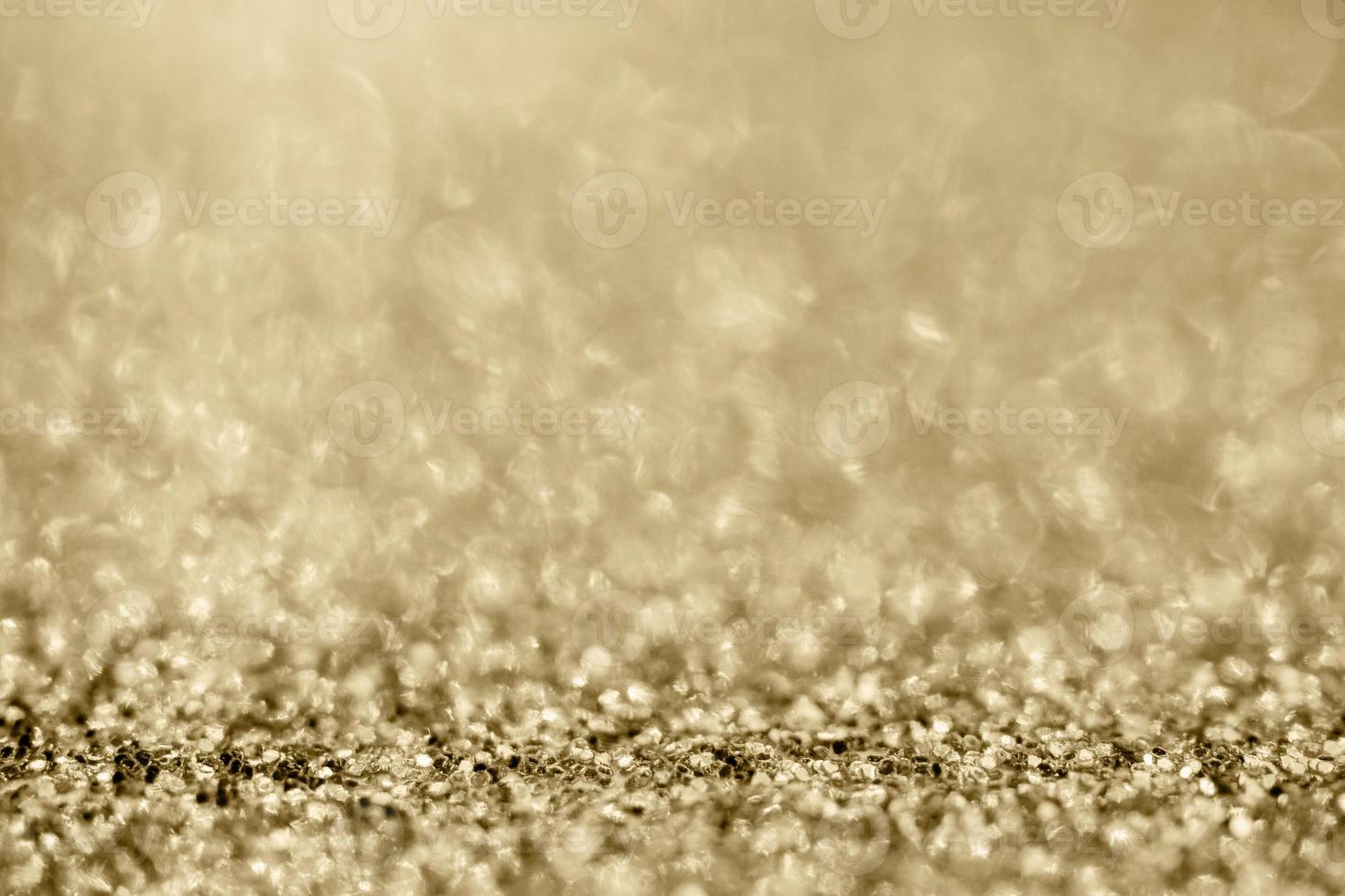 Abstract gold glitter sparkle blurred with bokeh background photo