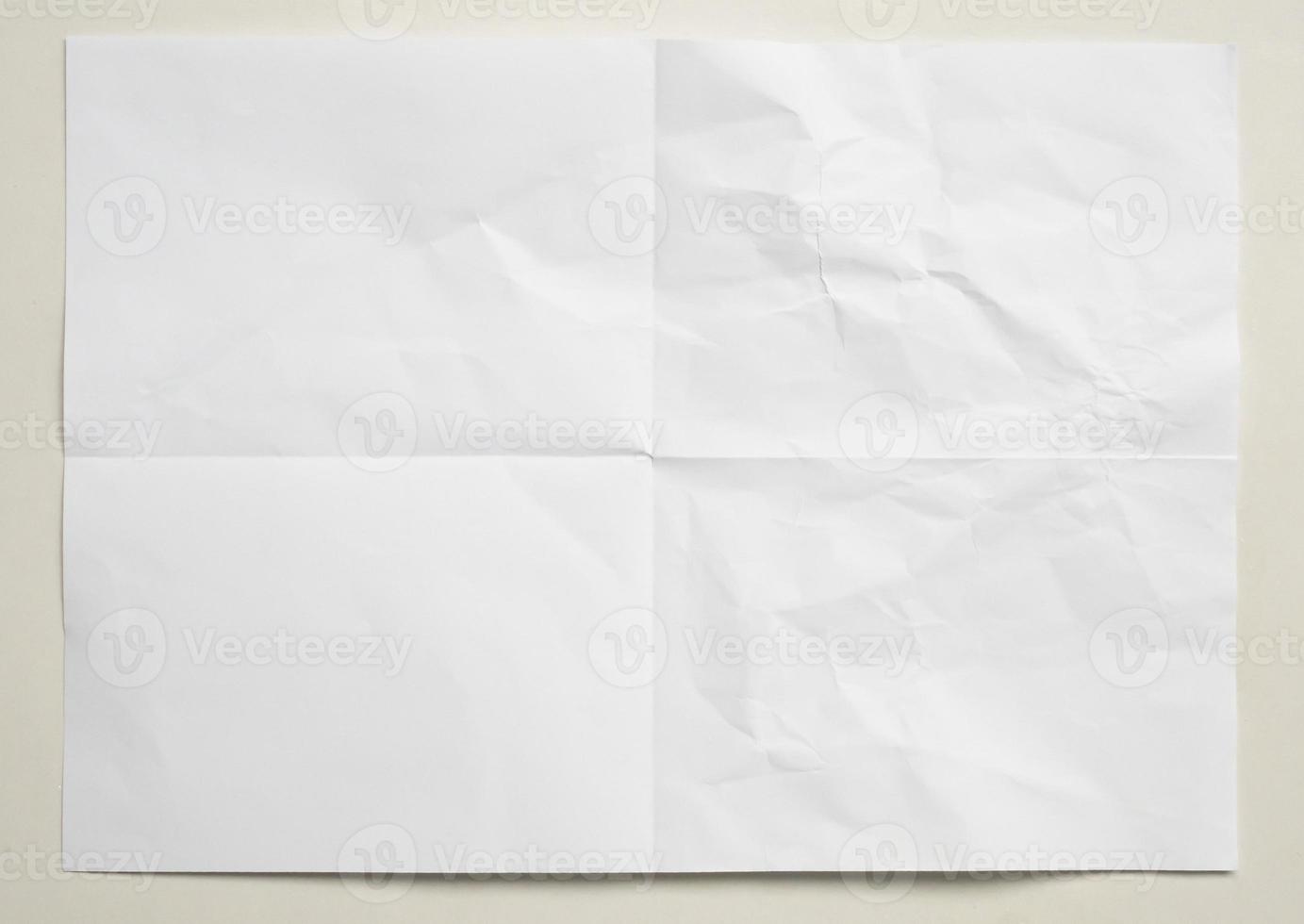 White folded and wrinkled paper on white background photo