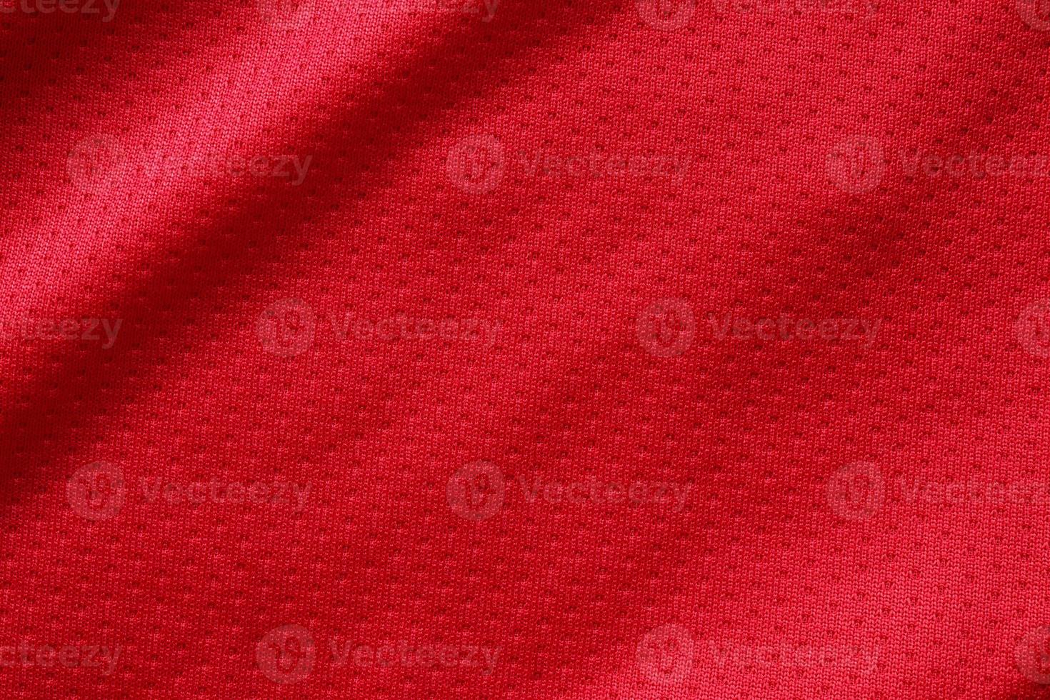 Red sports clothing fabric football shirt jersey texture close up photo